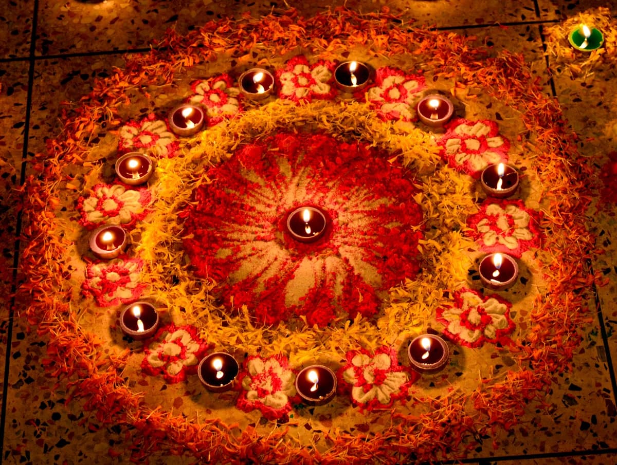 Circular rangoli of Diwali diyas + flowers — traditional home decoration 2026