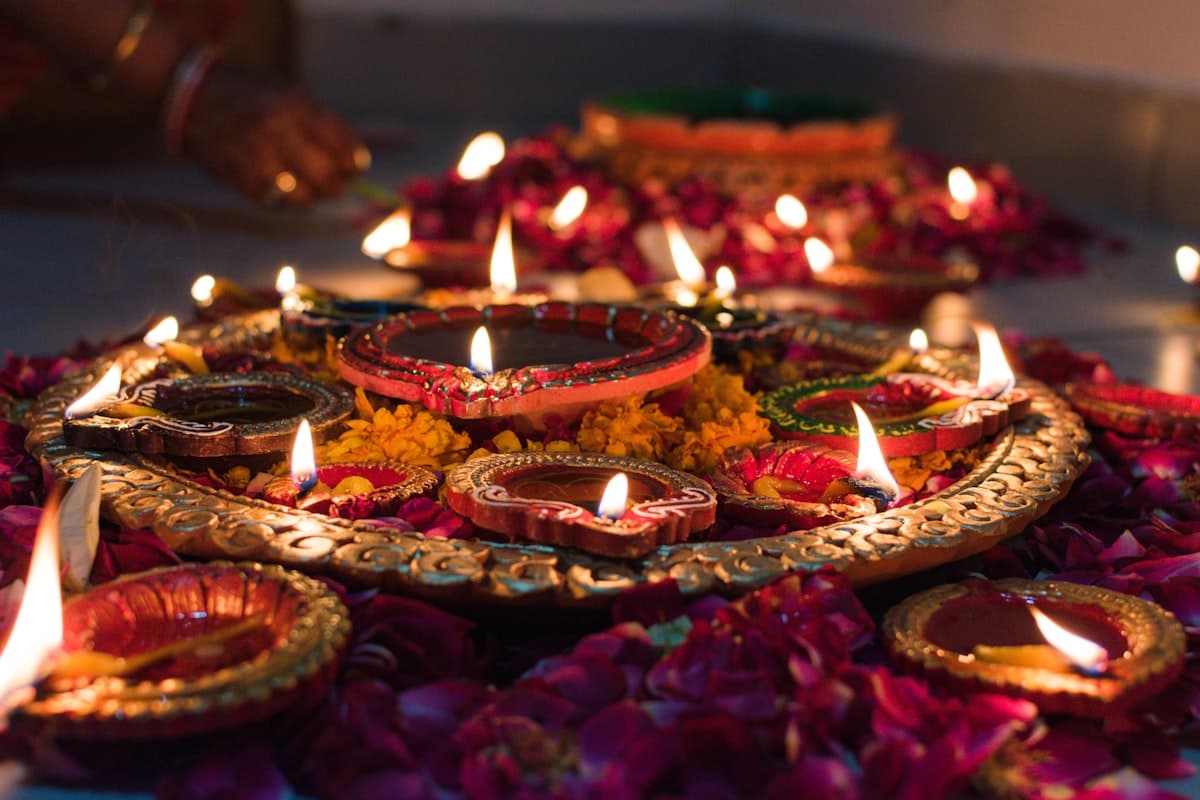 Traditional Diwali diyas arranged on decorative tray with rose petals — Deepavali 2026