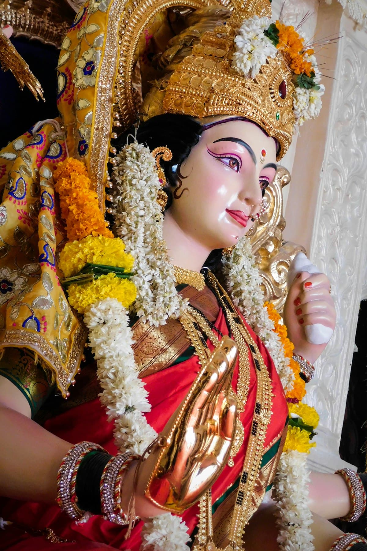 Durga Devi with gold jewelry and marigold garlands — Vijayadashami puja 2026