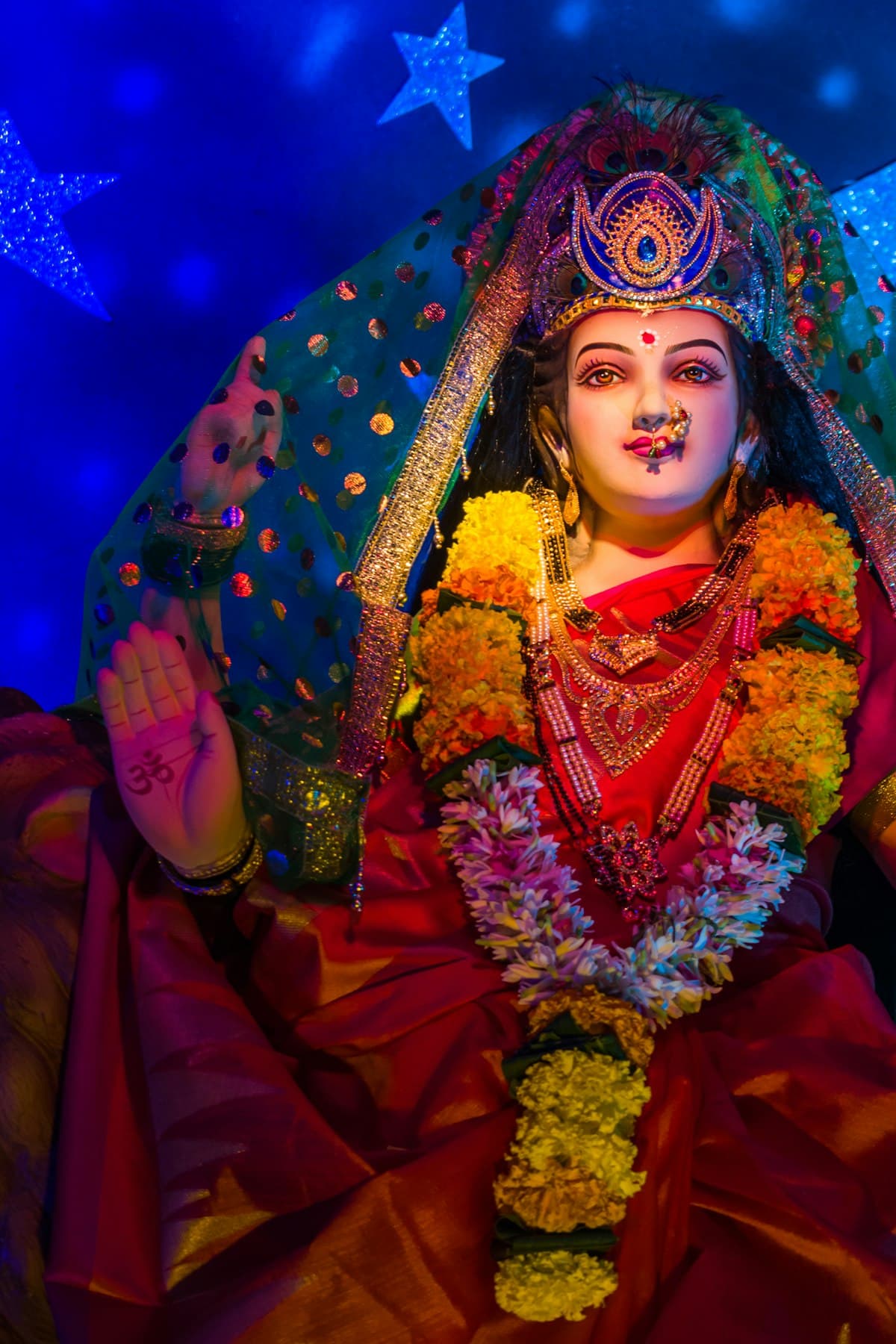 Goddess Durga idol in red sari with floral garlands — Dussehra Navratri 2026