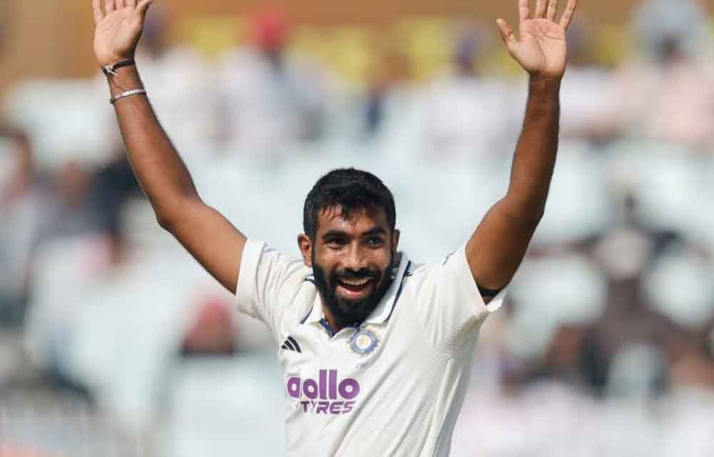 Jasprit Bumrah celebrating after taking a five-wicket haul against South Africa at Eden Gardens, with Indian teammates surrounding him and the crowd cheering in the background.